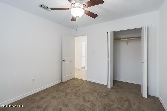 unfurnished bedroom featuring ceiling fan, carpet floors, and a closet