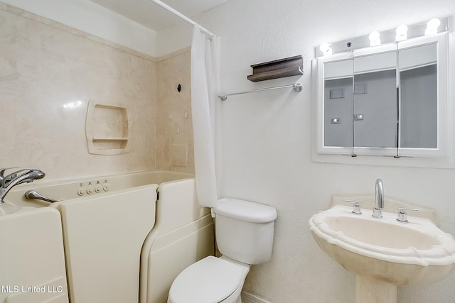 full bathroom featuring sink, shower / tub combo, and toilet