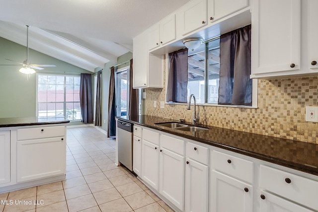 kitchen featuring white cabinetry, vaulted ceiling, and sink