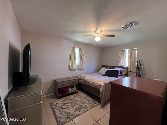 tiled bedroom with ceiling fan