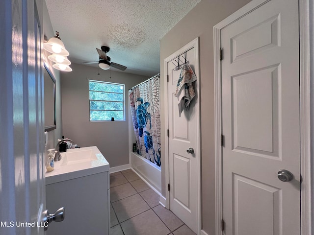 bathroom with tile patterned floors, shower / tub combo, vanity, a textured ceiling, and ceiling fan