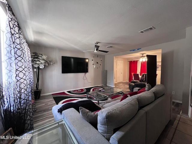 living room with wood-type flooring and ceiling fan