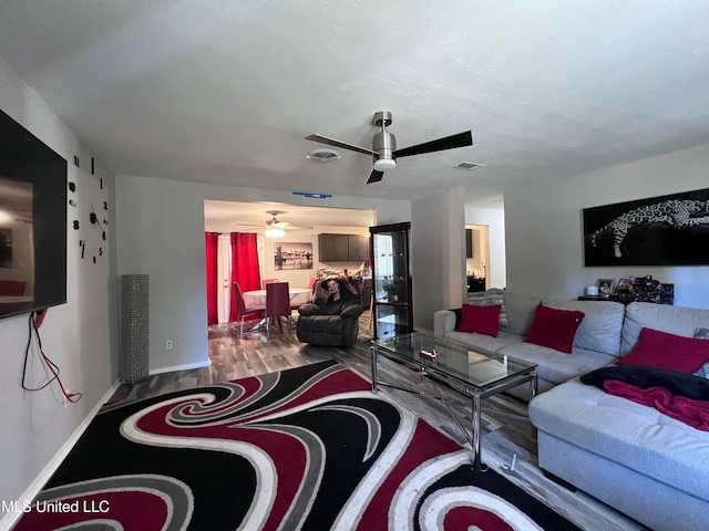 living room featuring hardwood / wood-style flooring and ceiling fan