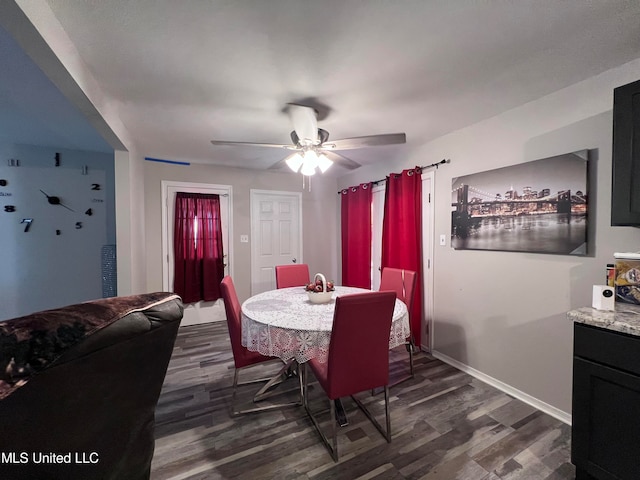 dining space featuring dark wood-type flooring and ceiling fan