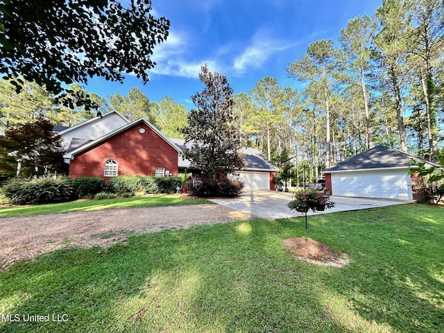 6520 Pleasant Grove Rd, Carthage, MS 39051 - view of home's exterior featuring brick siding, concrete driveway, a lawn, and a garage