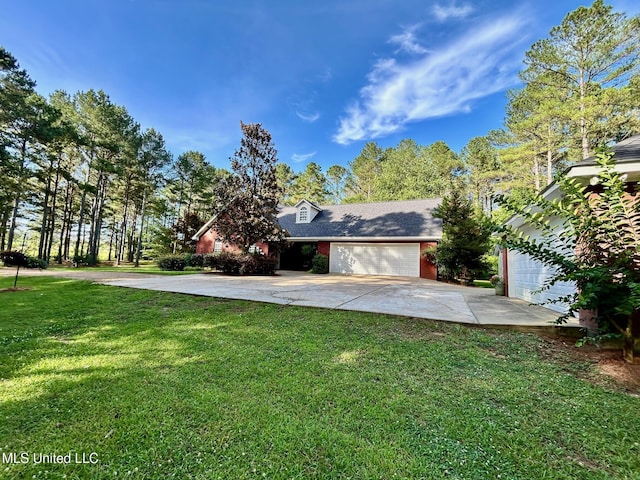 6520 Pleasant Grove Rd, Carthage, MS 39051 - view of grassy yard featuring driveway and a garage