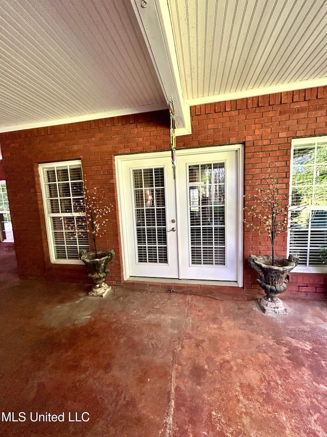 6520 Pleasant Grove Rd, Carthage, MS 39051 - doorway to property with french doors, a patio area, and brick siding