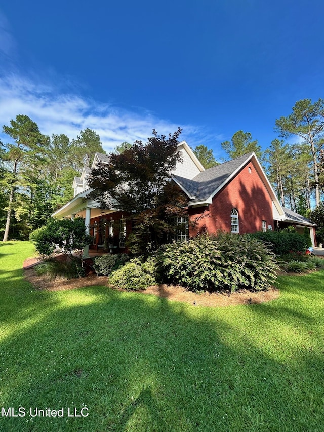 6520 Pleasant Grove Rd, Carthage, MS 39051 - view of side of home featuring a lawn and brick siding