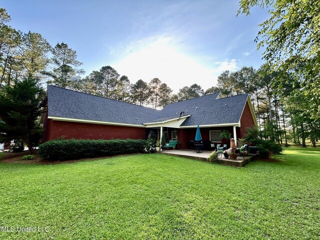 6520 Pleasant Grove Rd, Carthage, MS 39051 - back of house featuring a patio, a yard, and a shingled roof