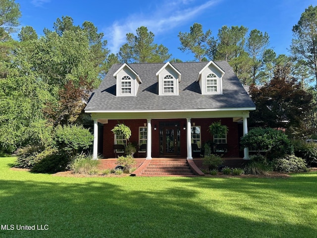 6520 Pleasant Grove Rd, Carthage, MS 39051 - new england style home featuring covered porch, a front lawn, and a shingled roof