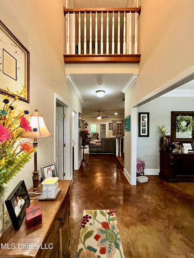 6520 Pleasant Grove Rd, Carthage, MS 39051 - entryway featuring a towering ceiling, ornamental molding, ceiling fan, and dark tile patterned flooring