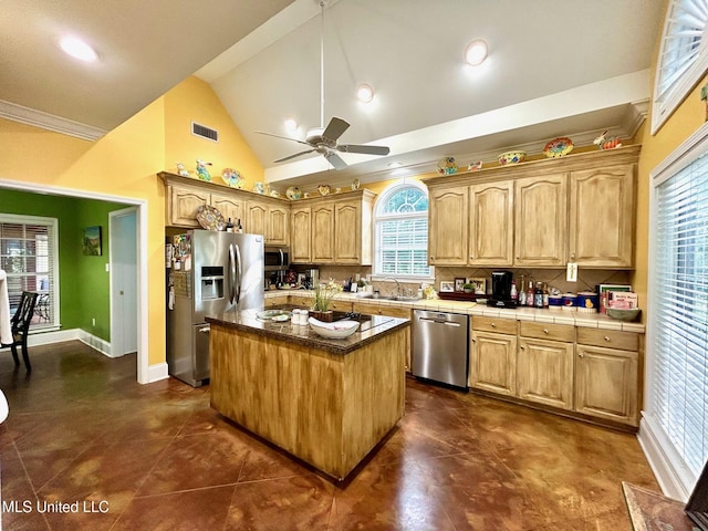 6520 Pleasant Grove Rd, Carthage, MS 39051 - kitchen with appliances with stainless steel finishes, ceiling fan, a center island, tile counters, and high vaulted ceiling