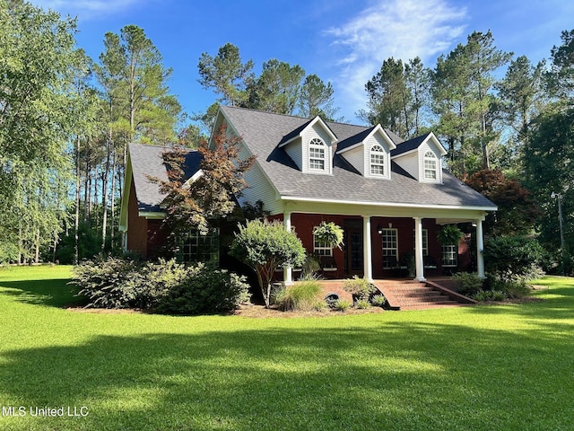 6520 Pleasant Grove Rd, Carthage, MS 39051 - cape cod house featuring a front lawn, covered porch, and roof with shingles