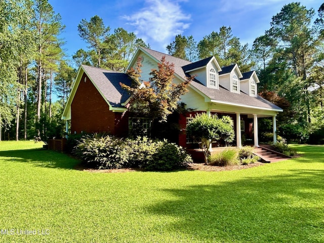 6520 Pleasant Grove Rd, Carthage, MS 39051 - view of side of home with a lawn, covered porch, and a shingled roof