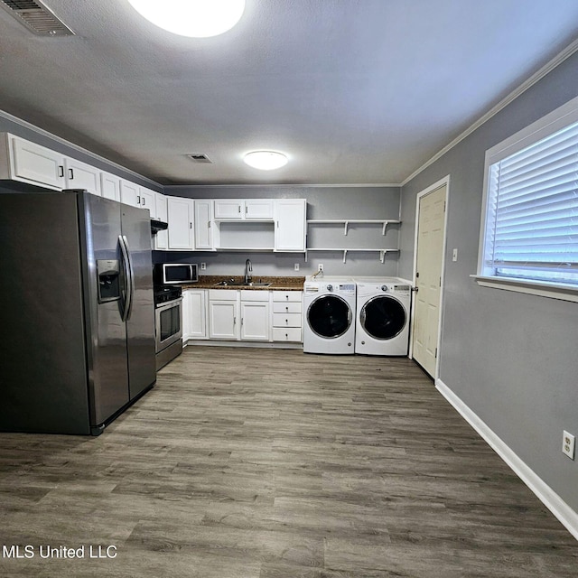 6688 Balboa Cir, Ocean Springs, MS 39564 - laundry area with independent washer and dryer, ornamental molding, dark wood-style flooring, and baseboards