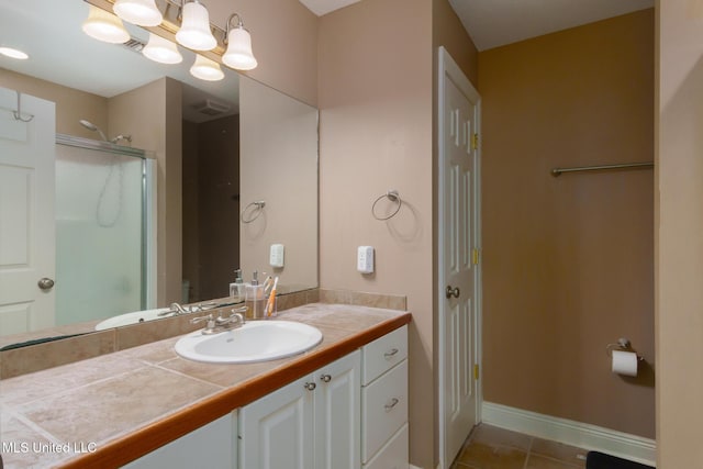 bathroom with vanity, tile patterned floors, an inviting chandelier, and walk in shower