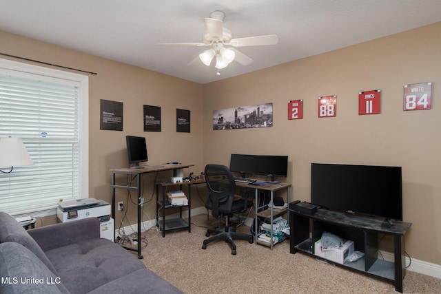 carpeted office featuring ceiling fan