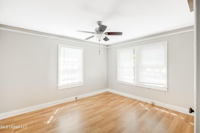 unfurnished room with baseboards, ceiling fan, and wood finished floors