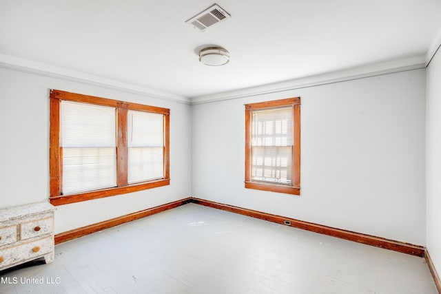 unfurnished room featuring visible vents and baseboards