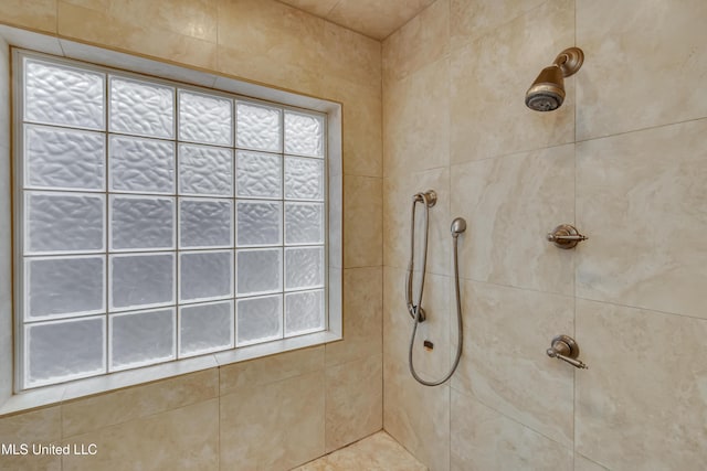 full bath featuring a tile shower