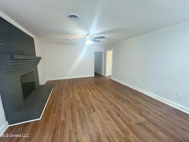 unfurnished living room featuring hardwood / wood-style flooring, ceiling fan, crown molding, and a fireplace