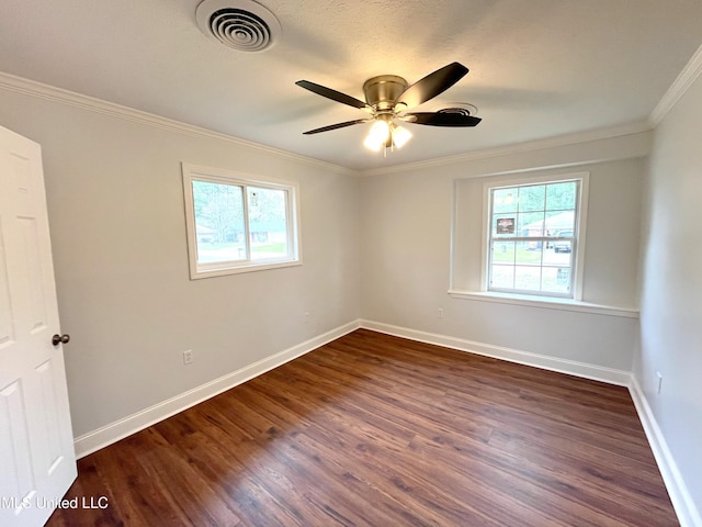 unfurnished room featuring ornamental molding, plenty of natural light, dark wood-type flooring, and ceiling fan