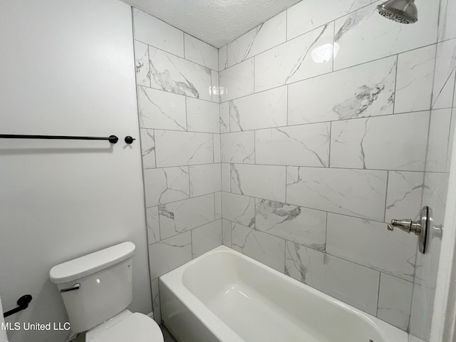 bathroom featuring toilet and tiled shower / bath