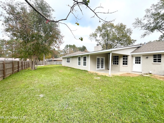 back of house with a lawn, french doors, and a patio