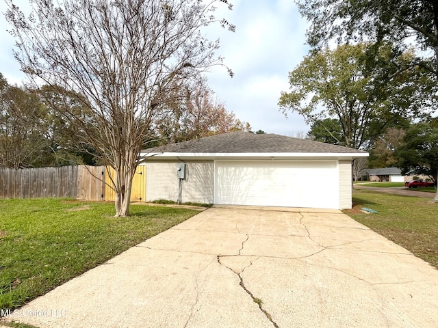 view of front of house featuring a garage and a front lawn