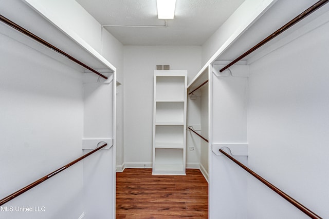 walk in closet featuring dark hardwood / wood-style flooring