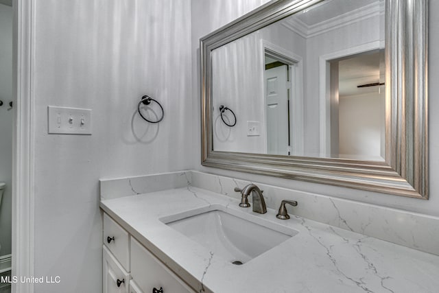 bathroom featuring vanity and ornamental molding