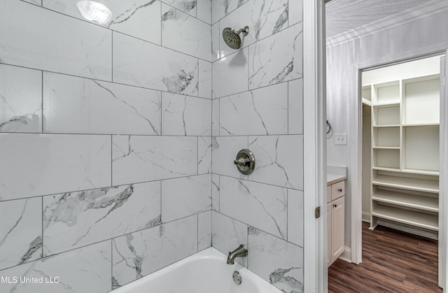 bathroom with vanity, tiled shower / bath combo, and hardwood / wood-style flooring