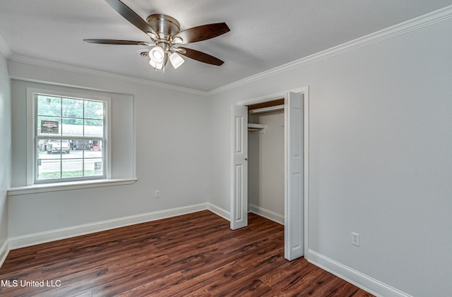 unfurnished bedroom featuring ceiling fan, dark hardwood / wood-style flooring, and crown molding