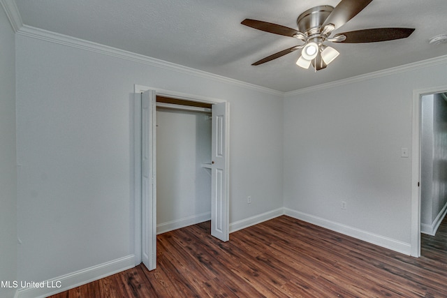 unfurnished bedroom with ceiling fan, dark wood-type flooring, crown molding, a textured ceiling, and a closet