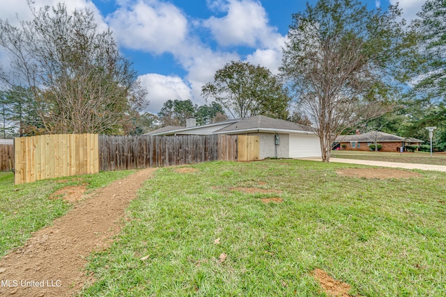 exterior space featuring a garage and a front lawn