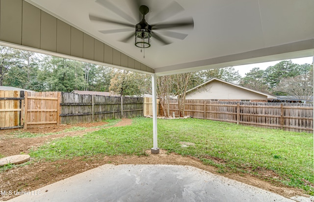 view of yard featuring a patio area and ceiling fan