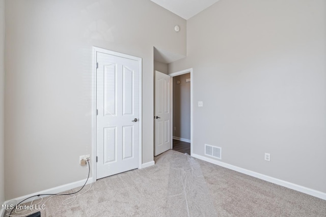 unfurnished bedroom featuring light carpet