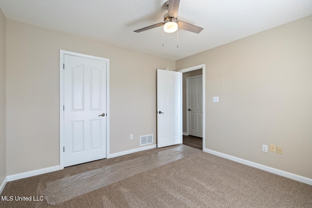 unfurnished bedroom with carpet flooring and ceiling fan