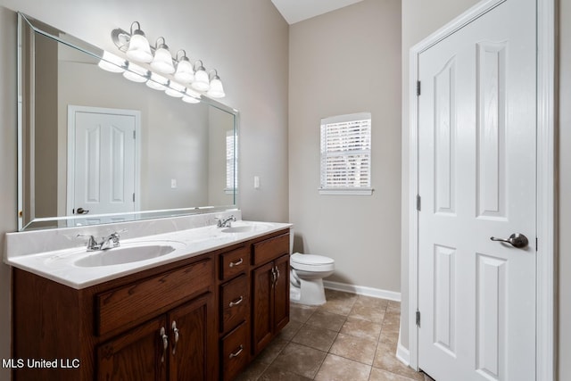 bathroom featuring toilet, tile patterned flooring, and vanity