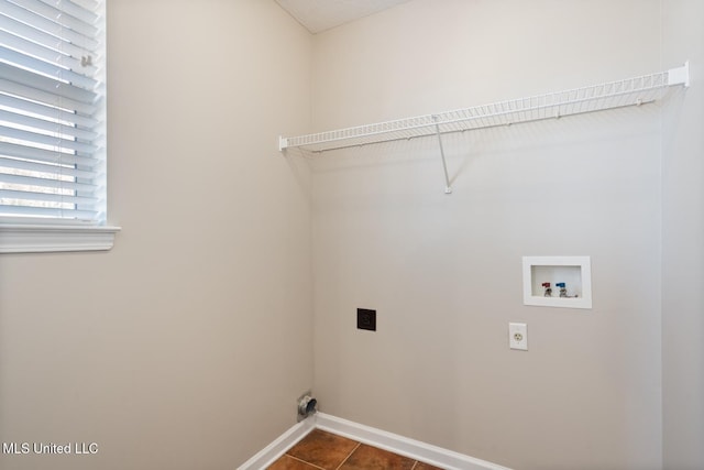 laundry area with washer hookup, electric dryer hookup, and dark tile patterned flooring