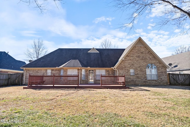 back of house with a yard and a deck