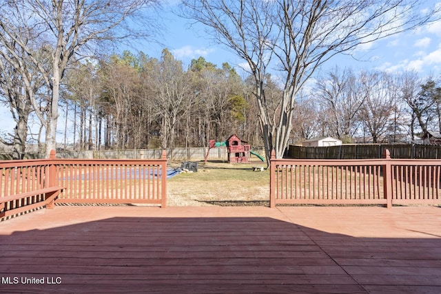 deck featuring a playground and a lawn