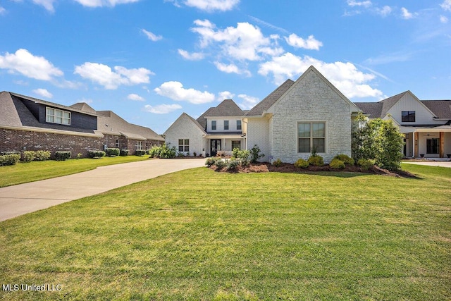 french country home featuring a front lawn