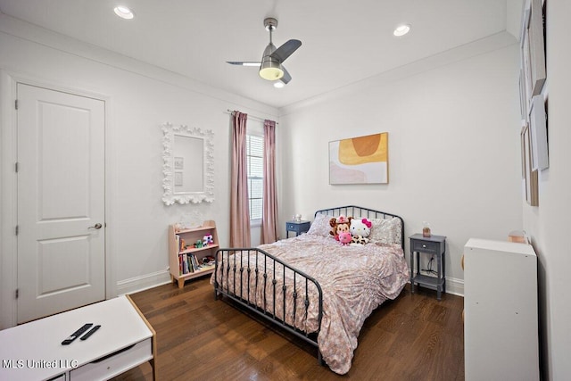 bedroom featuring crown molding, ceiling fan, and dark hardwood / wood-style flooring