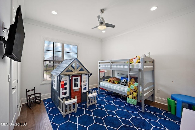 bedroom with ceiling fan, crown molding, and dark hardwood / wood-style flooring