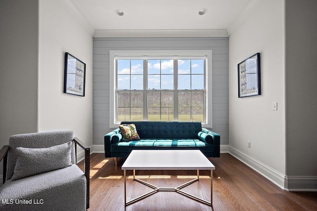 living room with crown molding and hardwood / wood-style floors