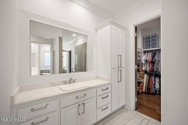 bathroom featuring vanity, walk in shower, and wood-type flooring