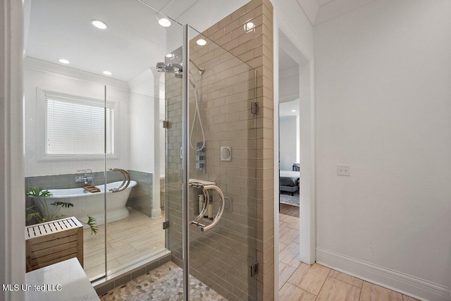 bathroom with hardwood / wood-style flooring and separate shower and tub