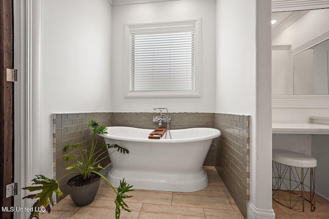 bathroom with tile walls, tile patterned floors, and a bathtub