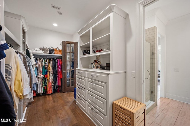 walk in closet featuring hardwood / wood-style floors